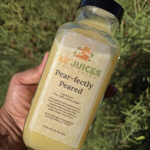 Hand holding bottle of pear juice
