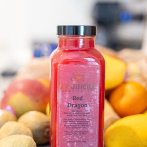 Red Dragon juice bottle surrounded by fruit
